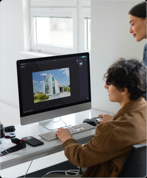 Real estate media professionals reviewing an enhanced property image